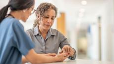 A healthcare provider and another person looking at something